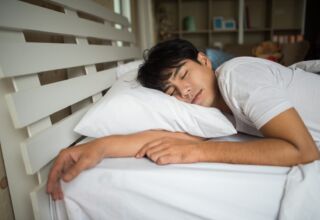 Man sleeping on bed in the morning