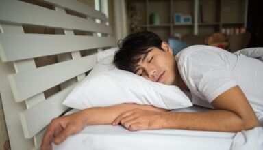 Man sleeping on bed in the morning