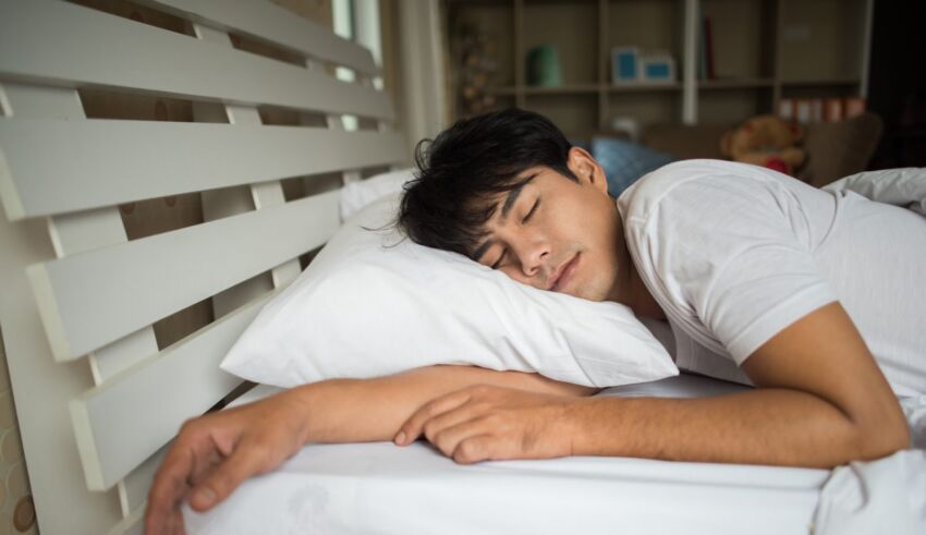 Man sleeping on bed in the morning